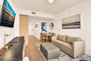 a living room with a couch and a table at Miami Oasis 2BR Apt Pool & Beach Access for 5 in Miami