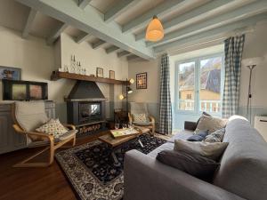 a living room with a couch and a fireplace at Chez requenna in Borce