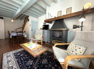 a living room with a couch and a fireplace at Chez requenna in Borce