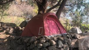 a red tent sitting on top of a pile of rocks at Patziapa in Santiago Atitlán