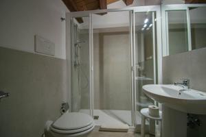 a bathroom with a shower and a toilet and a sink at Case Ruggero in Cefalù +9 photos