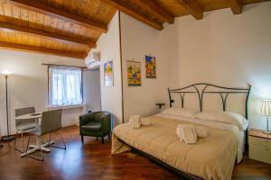 a bedroom with a bed and a desk and a table at Case Ruggero in Cefalù