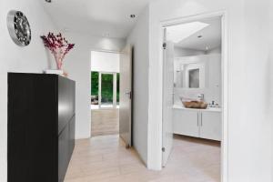 a white kitchen with a black and white hallway at Spacious Luxury Villa Apartment - Two Bedrooms in Egå