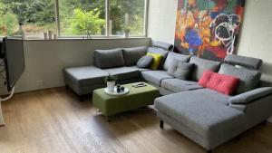 a living room with a couch and a table at Spacious Luxury Villa Apartment - Two Bedrooms in Egå