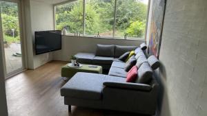 a living room with a couch and a flat screen tv at Spacious Luxury Villa Apartment - Two Bedrooms in Egå +11 photos