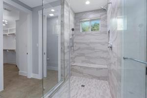 a bathroom with a shower with a glass door at Gatlin Getaway in Dripping Springs