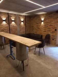 a large wooden table in a room with chairs at Port Stobno - Portowe Domki przy Winnicy in Stobno +36 photos