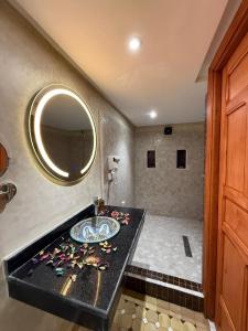 a bathroom with a sink and a mirror at Riad Mira in Fez +89 photos
