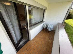 a porch with a glass door and a chair at Apartment Alex in Hildesheim