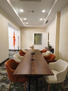 a conference room with a wooden table and chairs at Hotel Turist - City Center in Skopje