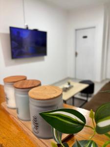 a table with three coffee cups on top of it at Pura Vida Apartment in Mostar