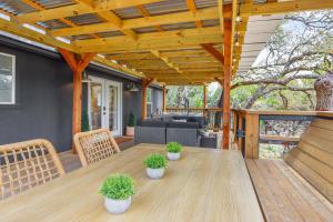 a patio with a wooden table and chairs at Good Day Treehouse in Wimberley
