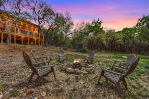 a group of chairs sitting around a fire pit at Good Day Treehouse in Wimberley
