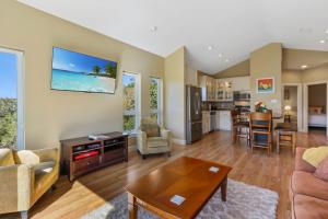 a living room with a couch and a table at Green Roof Cottage in Canyon Lake