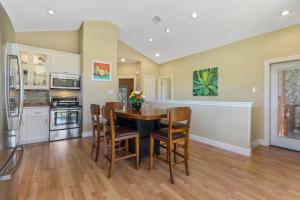 a kitchen and dining room with a table and chairs at Green Roof Cottage in Canyon Lake