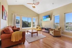 a living room with a couch and a table at Green Roof Cottage in Canyon Lake +31 photos