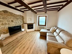 a living room with a couch and a fireplace at CASA LALLINO - Tuscan ToBe srl in Santa Fiora