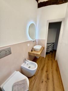 a bathroom with a white toilet and a sink at CASA LALLINO - Tuscan ToBe srl in Santa Fiora +12 photos