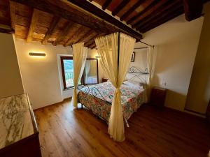 a bedroom with a bed with a canopy at CASA LALLINO - Tuscan ToBe srl in Santa Fiora