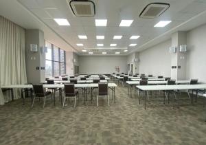 a large room with tables and chairs in it at Nord Luxxor Citymix in Campina Grande