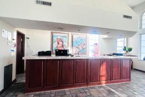 a large kitchen with a counter with a counter top at Osage Village Inn Near Lake Ozarks US 54 in Osage Beach