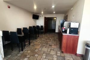 a dining room with a table and chairs and a refrigerator at Osage Village Inn Near Lake Ozarks US 54 in Osage Beach