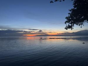 a sunset over a body of water at Ellen Homestay in San Juan