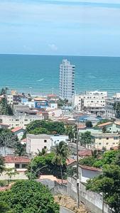 a view of a city with the ocean and buildings at Atlântico condomínio in Serra