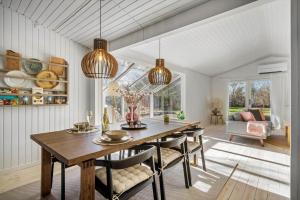 a dining room with a table and chairs at BL1163-Blokhus-Raappenmark-2 in Blokhus