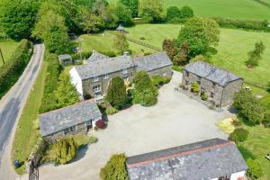 an aerial view of an old house with a driveway at Talehay Cottages in Looe