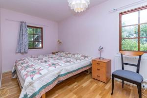 a bedroom with a bed and a desk and a chair at VGO922-Grabo-Strandkullen-22 in Gråbo