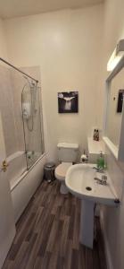 a bathroom with a sink and a toilet and a shower at Grindlay Street Residence, 2 Bedroom, 2 Bathroom apartment close to Castle in Edinburgh +24 photos