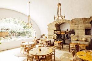 a dining room with tables and a large window at Le Moulin, Lourmarin, a Beaumier Hotel in Lourmarin +57 photos