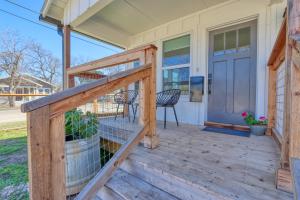 a front porch of a house with a wooden railing at Bridge Haus in New Braunfels +14 photos