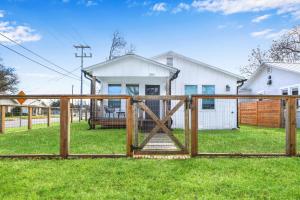 a wooden fence in front of a house at Bridge Haus in New Braunfels