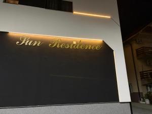 a sign for a juimo restaurant on the side of a building at Apartman Iva in Soko Banja