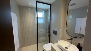 a bathroom with a sink and a shower with a mirror at Hatta Residence in Hatta