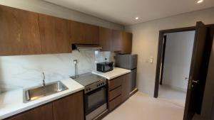 a kitchen with a sink and a stove at Hatta Residence in Hatta