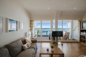 a living room with a couch and a tv at fewo1846 - Baltic Lodge - komfortable Maisonettewohnung mit 3 Schlafzimmern, Balkon und Blick auf die Marina Sonwik in Flensburg