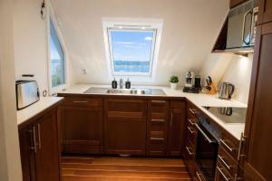 a kitchen with a sink and a window at fewo1846 - Baltic Lodge - komfortable Maisonettewohnung mit 3 Schlafzimmern, Balkon und Blick auf die Marina Sonwik in Flensburg