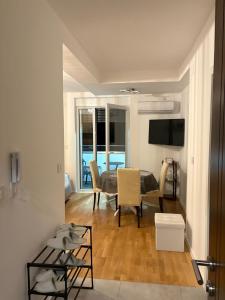 a living room with a table and chairs and a television at Apartman Iva in Soko Banja