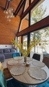 a dining room with a wooden table with chairs at Chalet Tri pramene in Moravské Lieskové