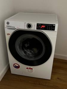 a white washing machine sitting in a room at Hostel PEREMOGA in Przemyśl