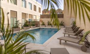 a swimming pool in the middle of a building at Ilunion Valencia 3 in Valencia +22 photos