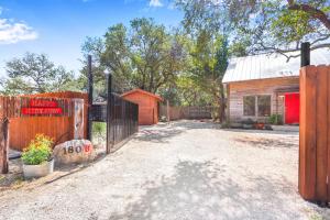 a gate in front of a building with a fence at Happy Hideaway in Wimberley