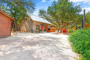 a barn with a truck parked next to a building at Happy Hideaway in Wimberley