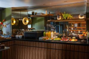 a kitchen with many plates of food on a counter at Hôtel Aoriste & Spa in Paris +38 photos