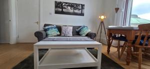 a living room with a couch and a table at Grindlay Street Residence, 2 Bedroom, 2 Bathroom apartment close to Castle in Edinburgh