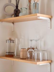 a shelf with glasses and other glass items on it at Palmito in Bidart
