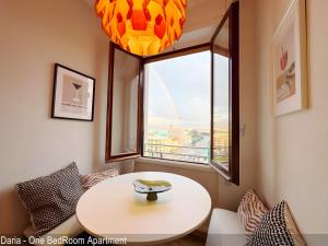 a table and chairs in a room with a window at Saverio & Daria Aprtements by Mamo Florence in Florence
